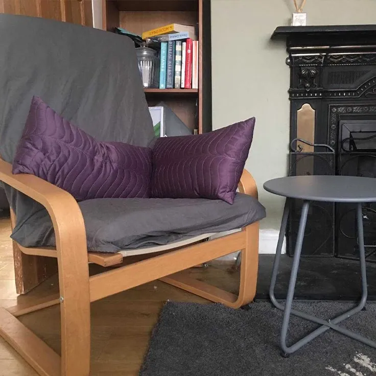 Counselling room with armchair and cushions